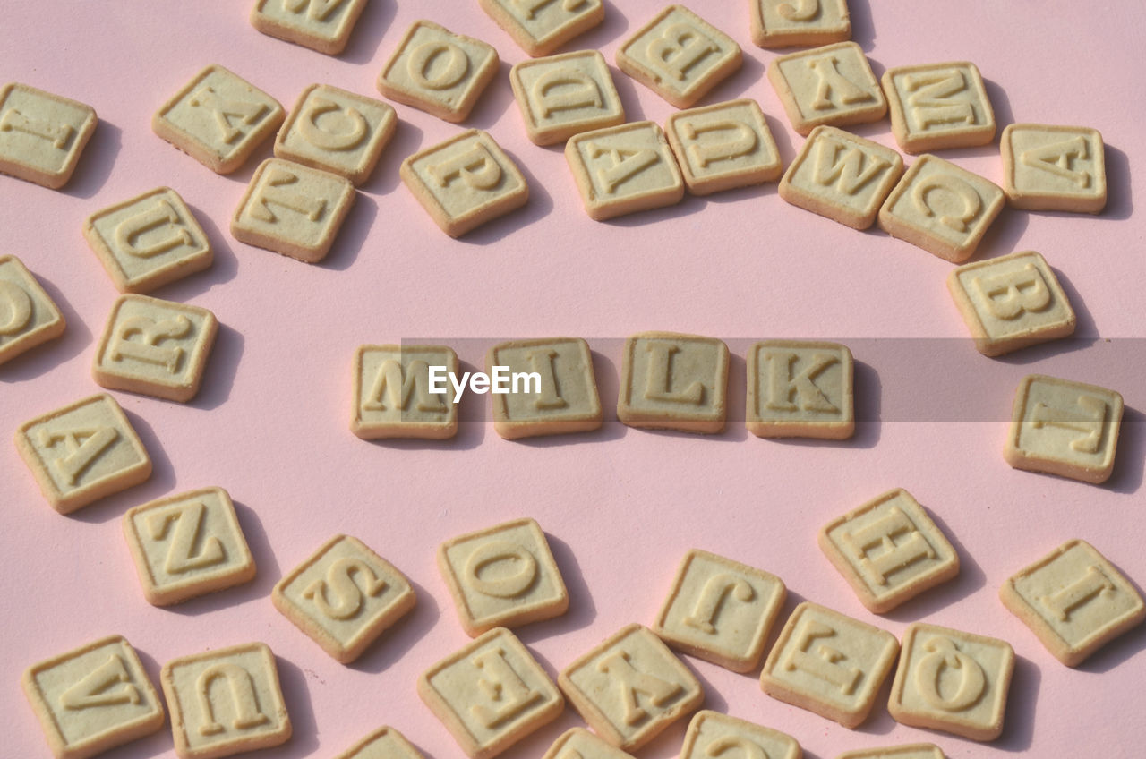 Close-up of alphabets on cookies over table