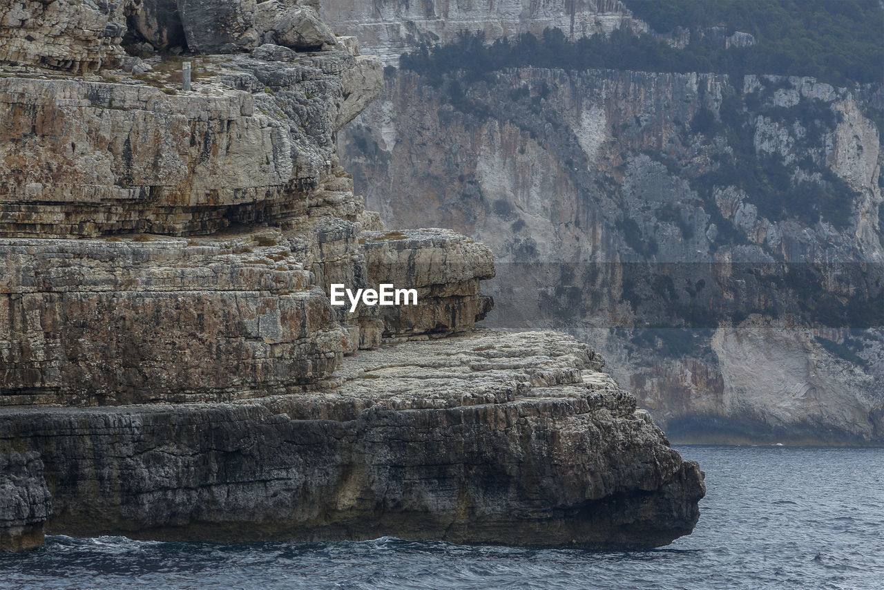 A massive rock that resembles a giant ship from the islands of the ionian sea