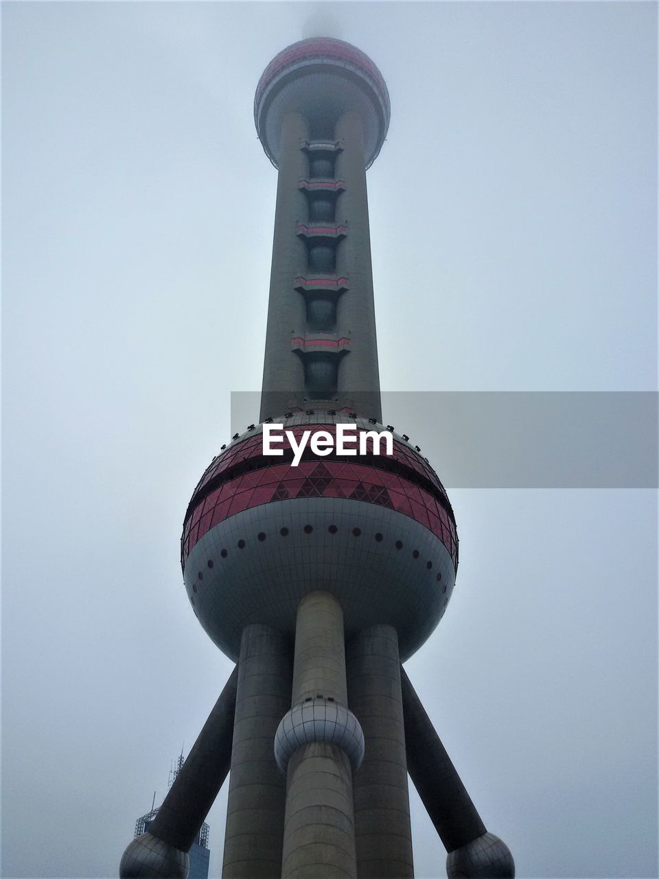 LOW ANGLE VIEW OF LIGHTHOUSE AGAINST BUILDINGS