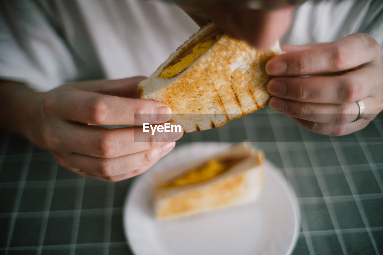 Cropped image of man eating breakfast