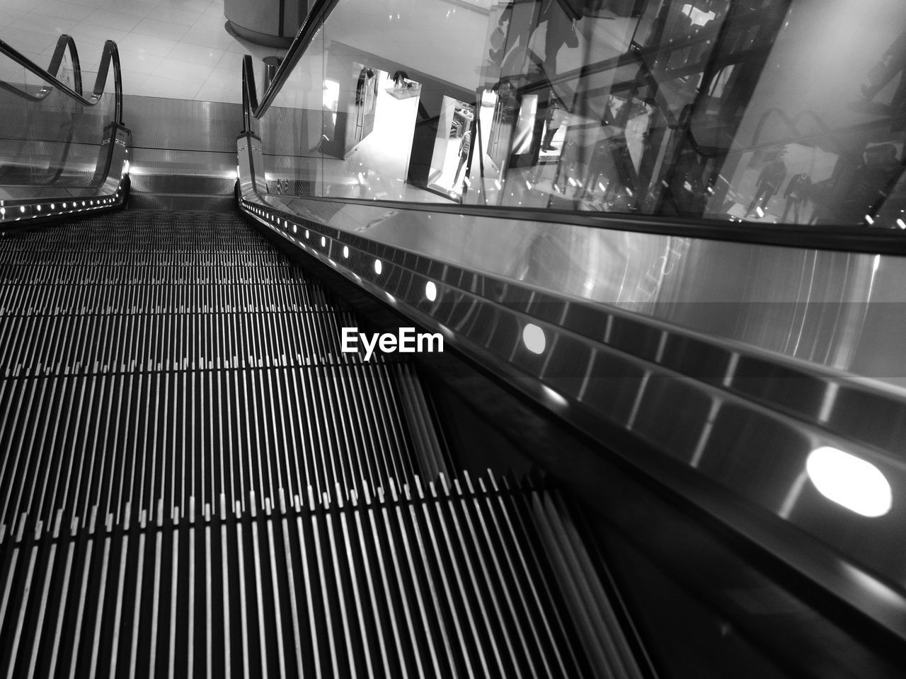 ESCALATOR IN ILLUMINATED UNDERGROUND