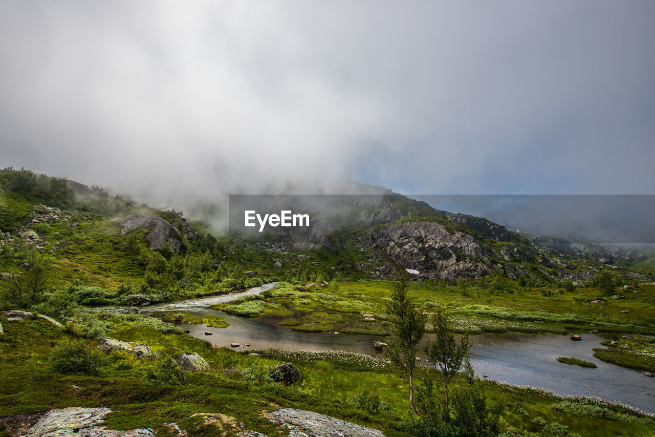 Scenic view of lake and mountains against sky