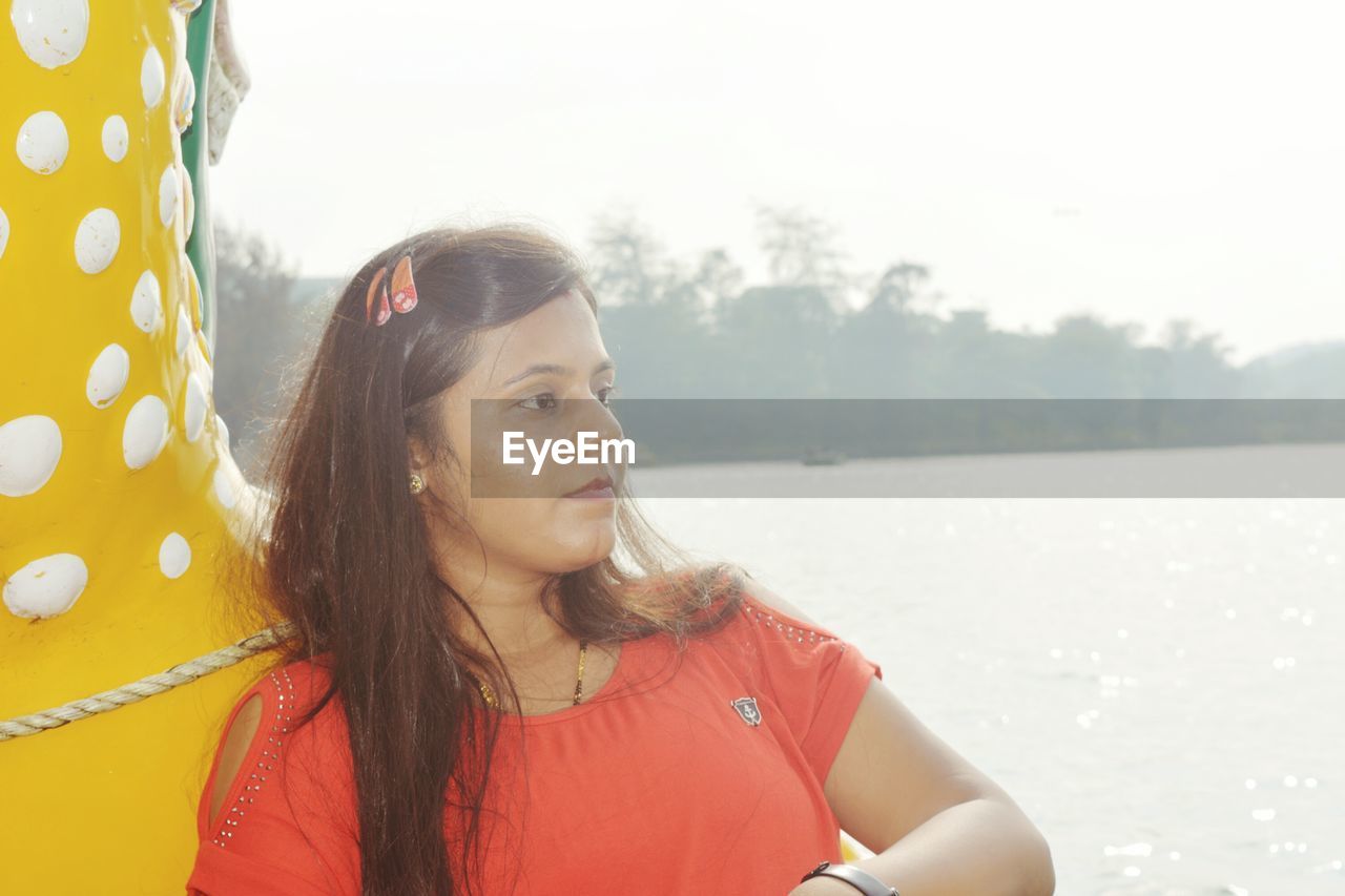 Woman sitting in boat on river