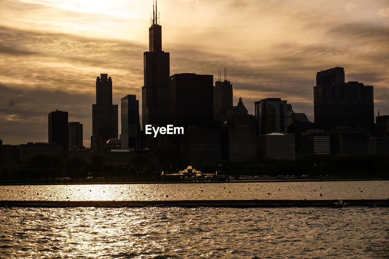 VIEW OF CITY AT WATERFRONT DURING SUNSET