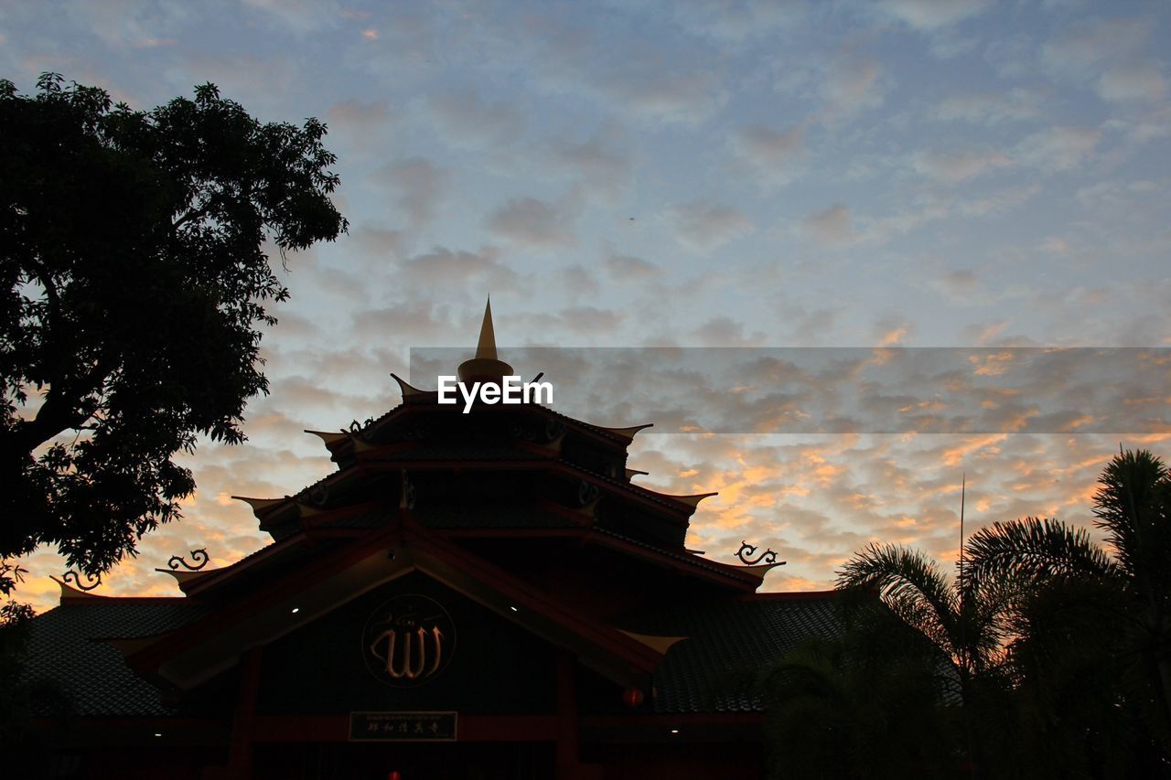 Temple against sky at sunset