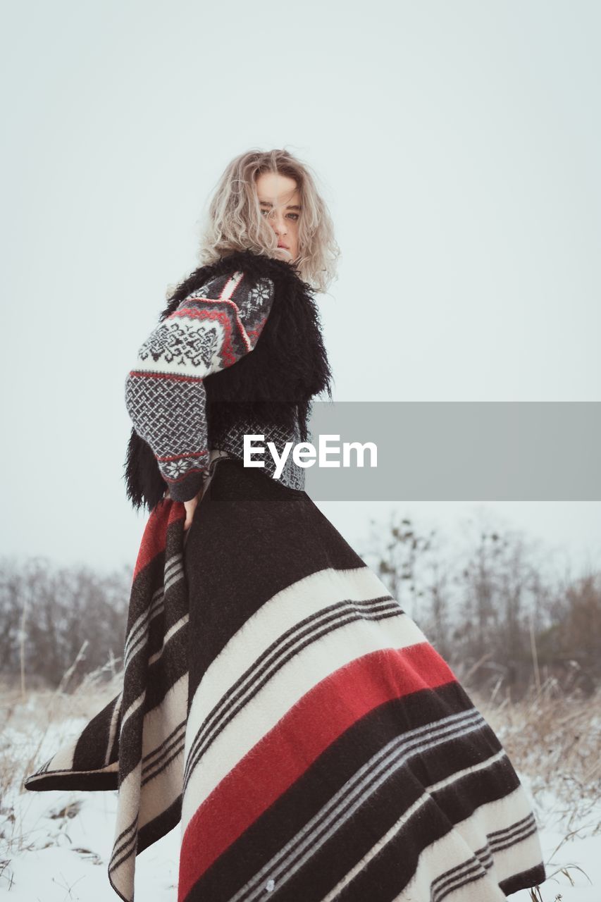 Pretty lady with woolen plaid in winter scenic photography