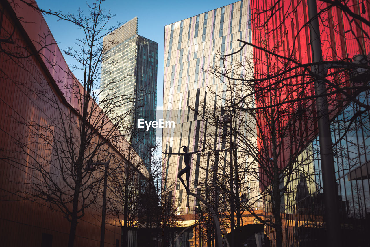 Colourful photo of high rise buildings on a city street. 