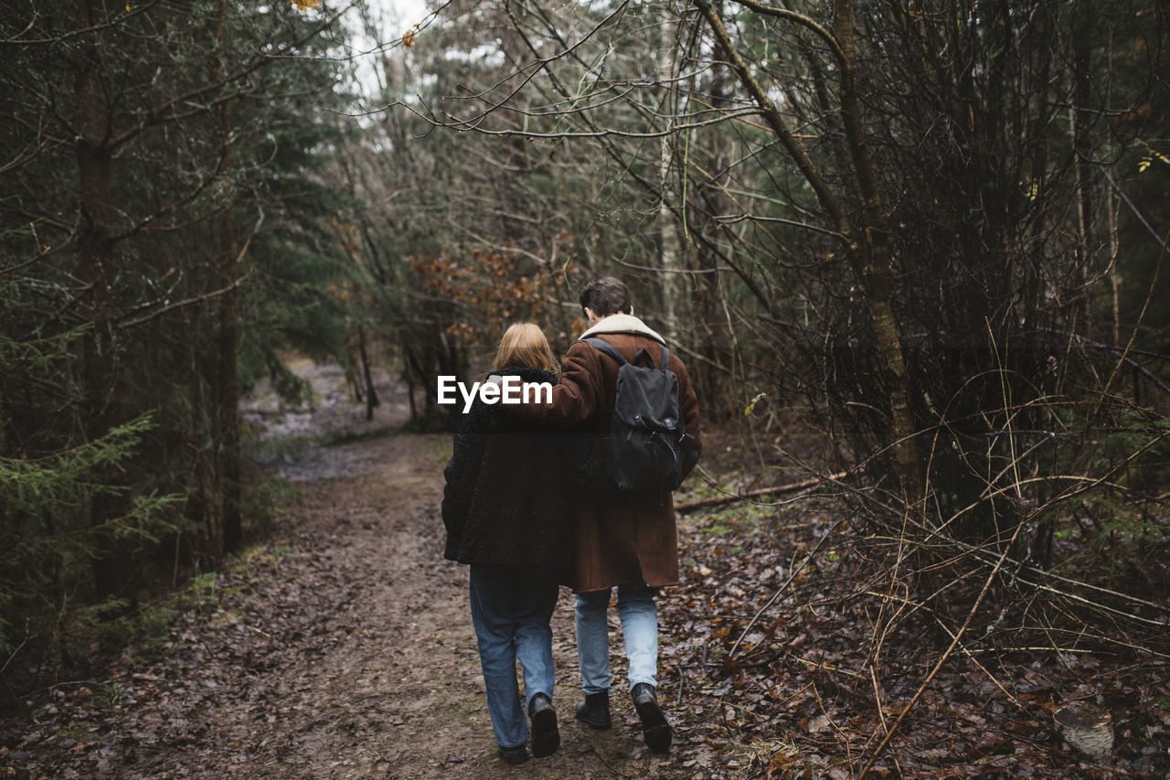 Couple walking through forest