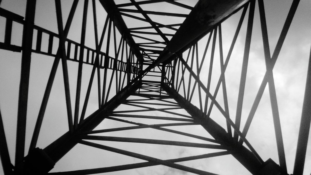 Directly below view of metallic tower against sky