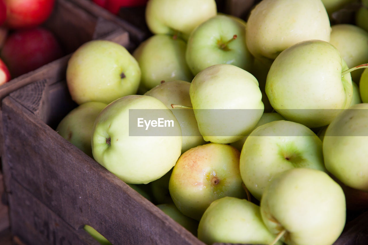 Close-up of ripe apples in wooden box