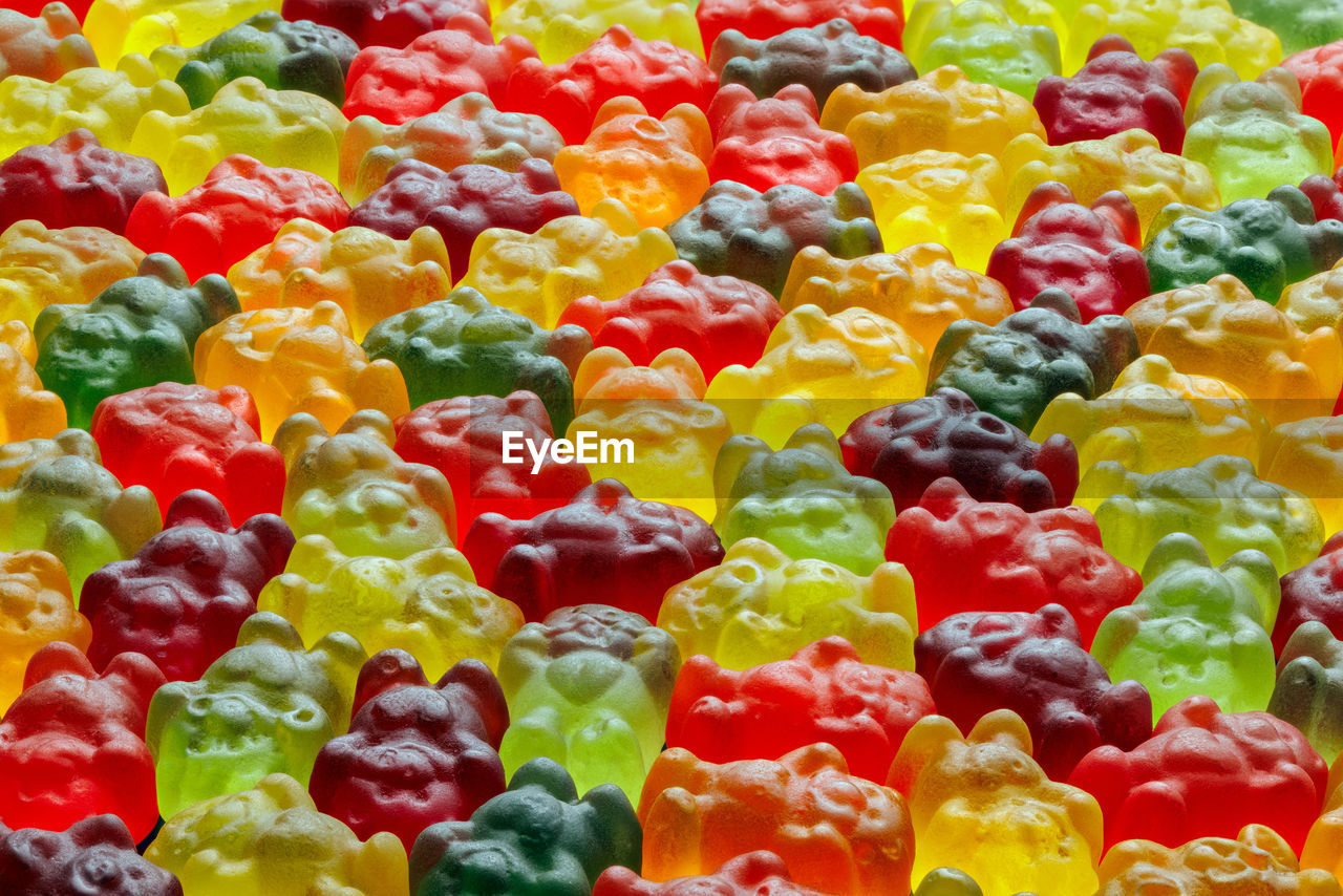 Full-frame background of colorful jelly bears laid closely on flat surface