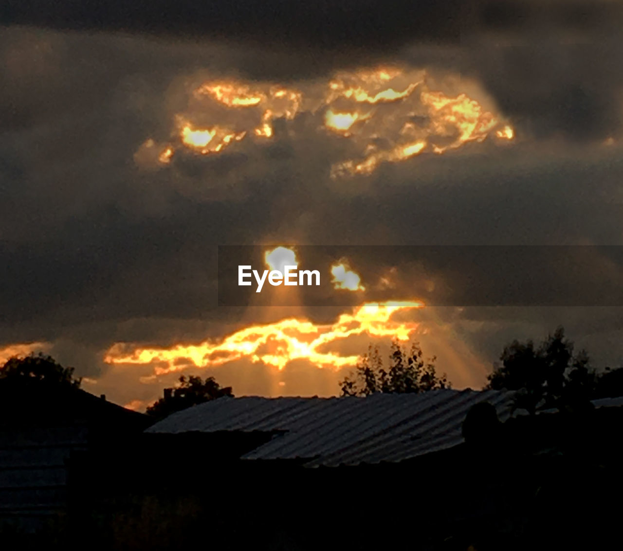 SILHOUETTE OF HOUSES AT SUNSET