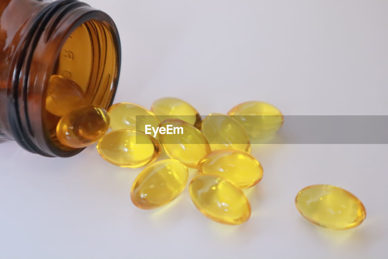 HIGH ANGLE VIEW OF YELLOW BOTTLES ON TABLE