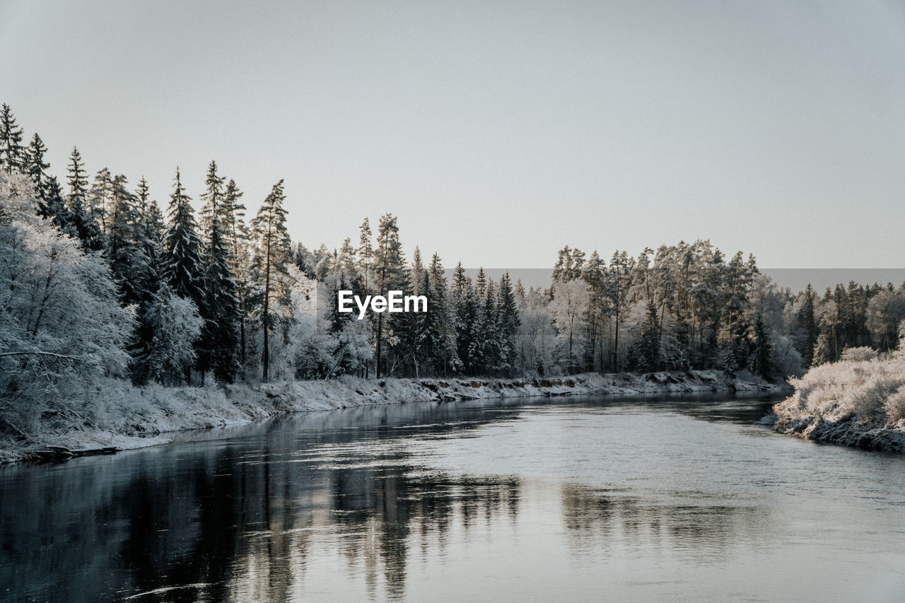 Scenic view of river against clear sky during winter