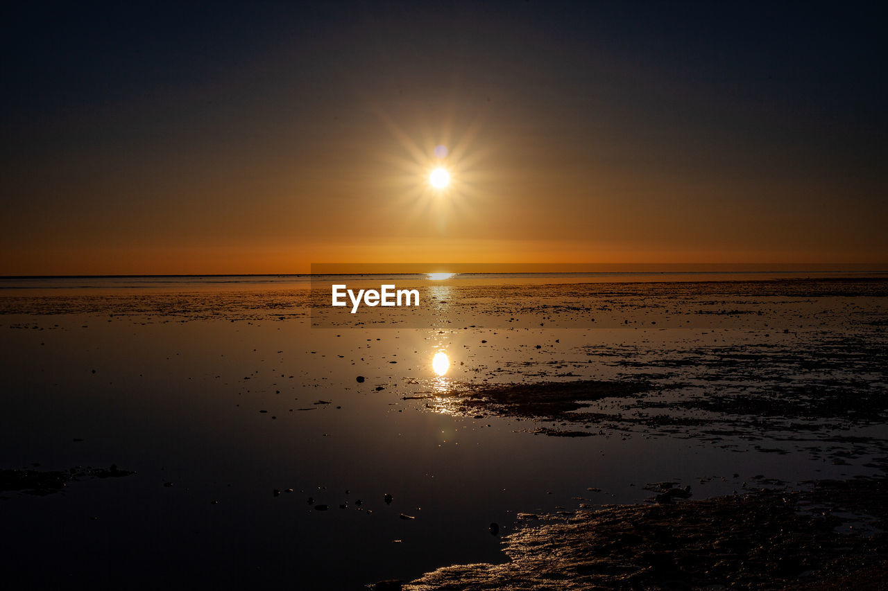 Scenic view of sea against sky at sunset