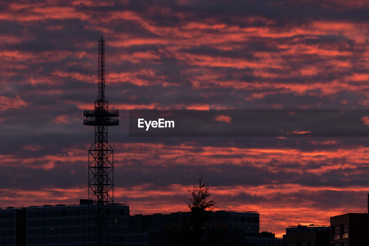 Low angle view of silhouette buildings against dramatic sky