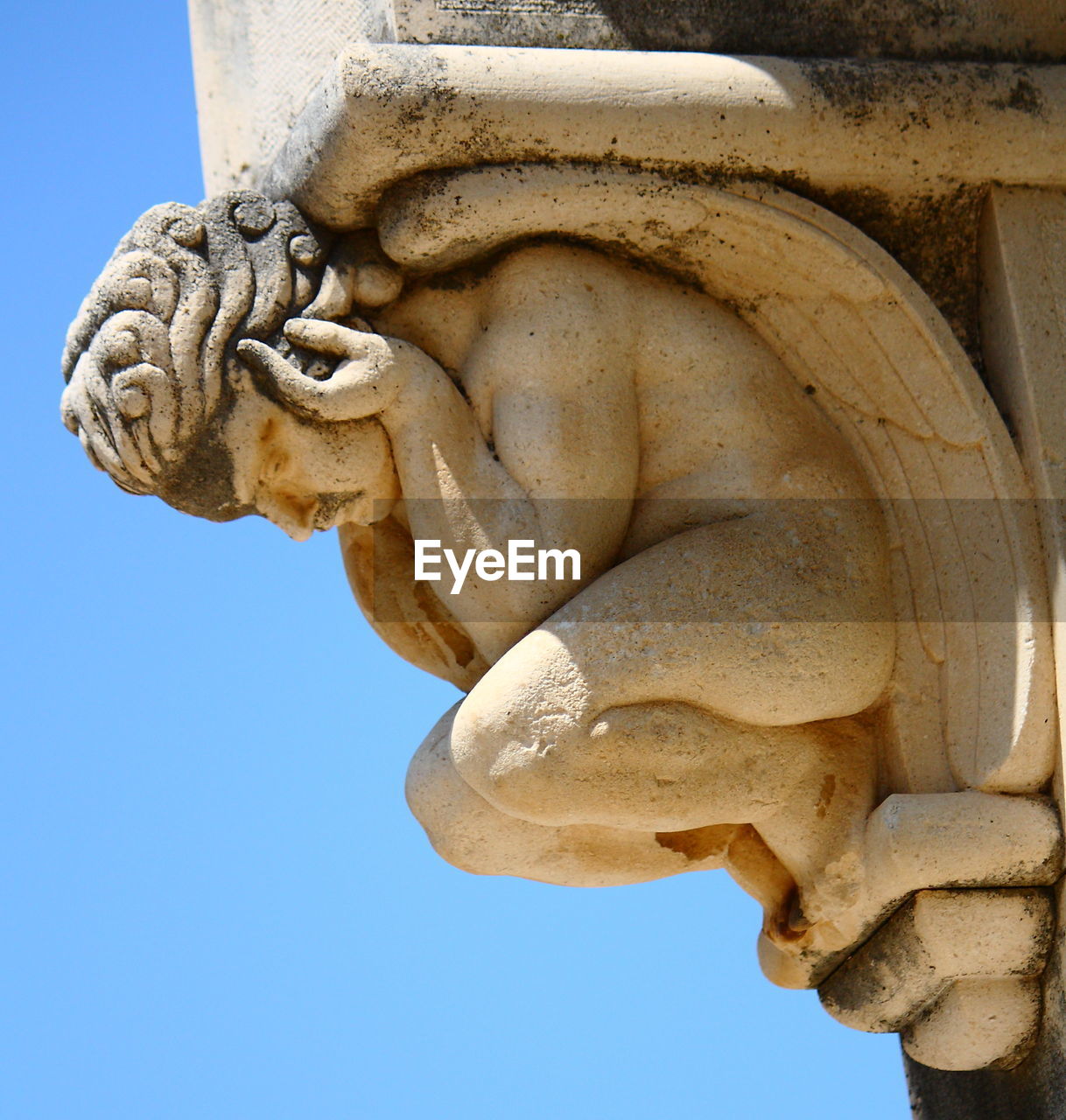 Low angle view of statue against blue sky