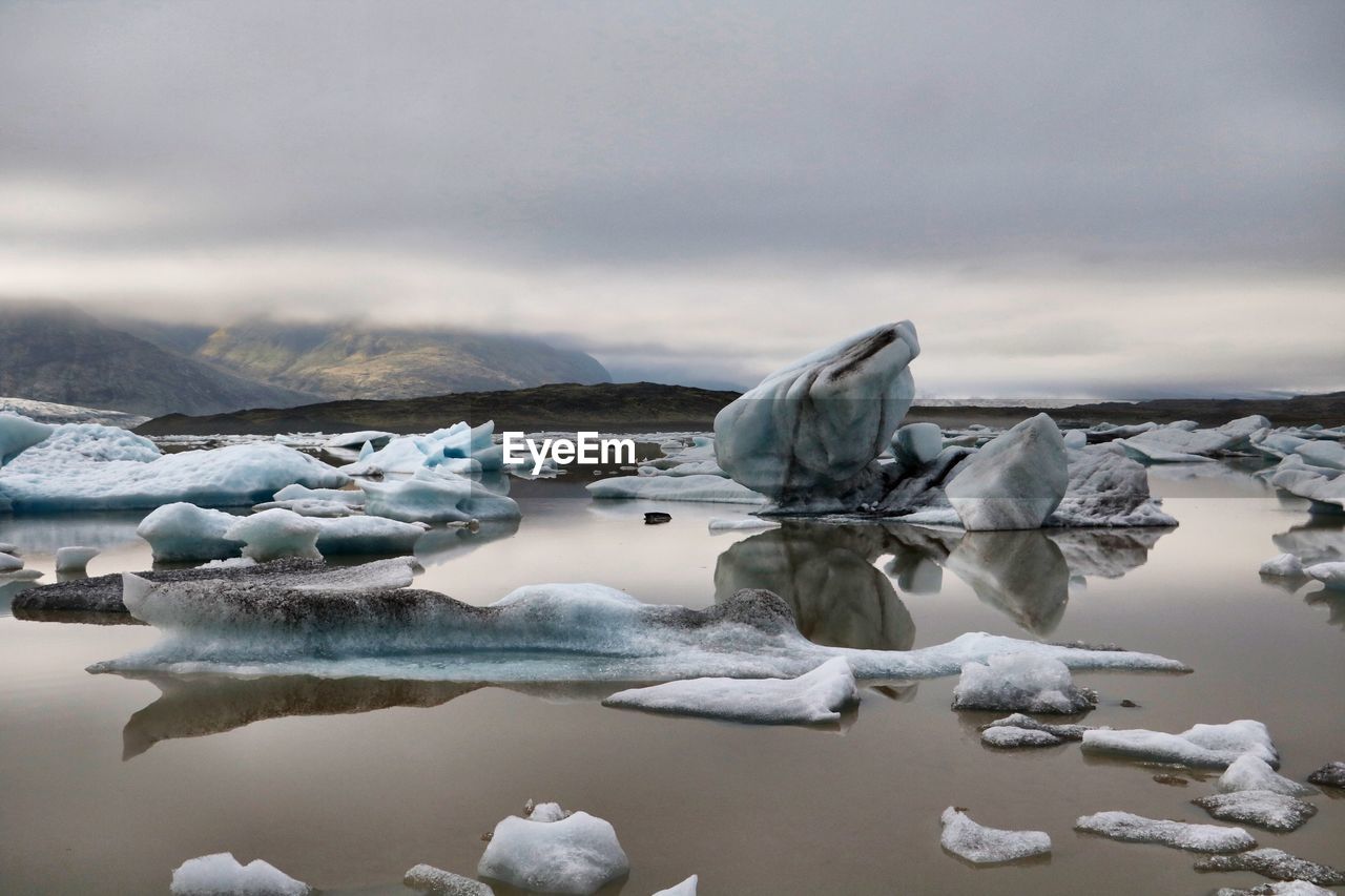 Frozen lake against sky during winter