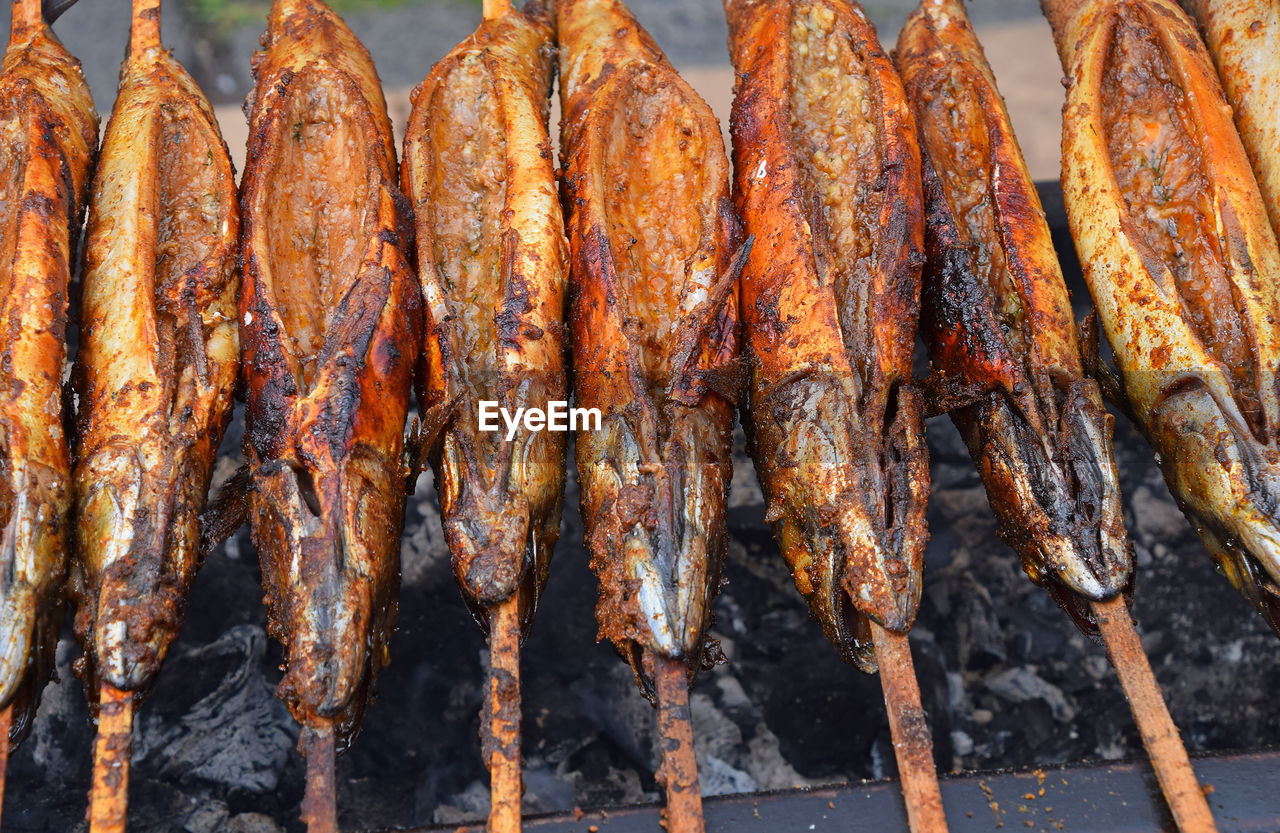 High angle view of fishes on barbecue grill