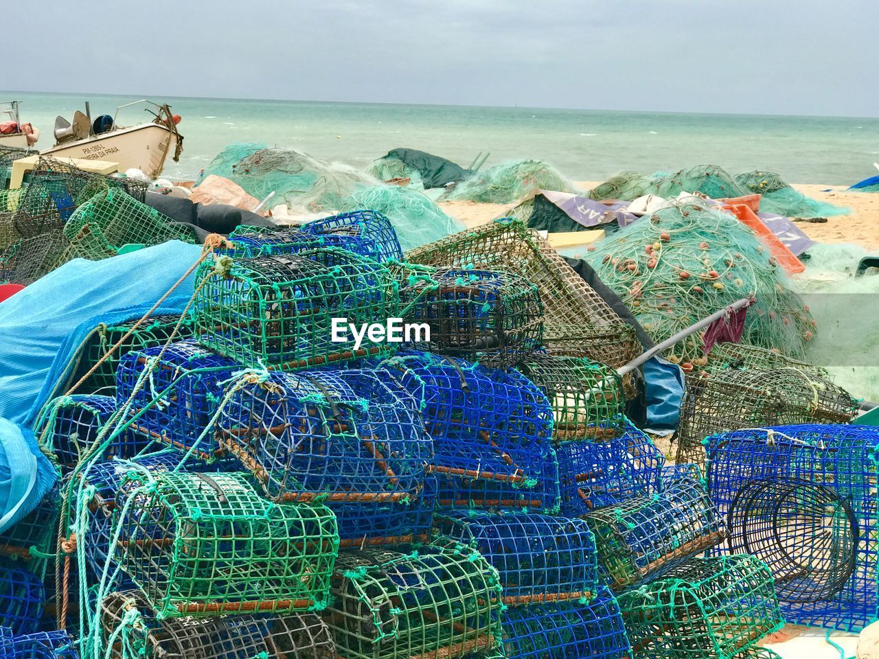 FISHING NET ON BEACH AGAINST SKY