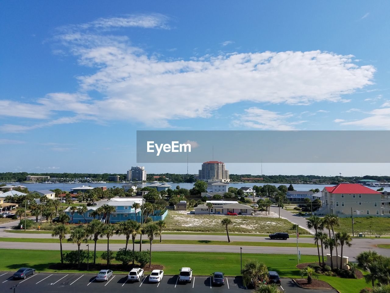 View of town by sea against sky