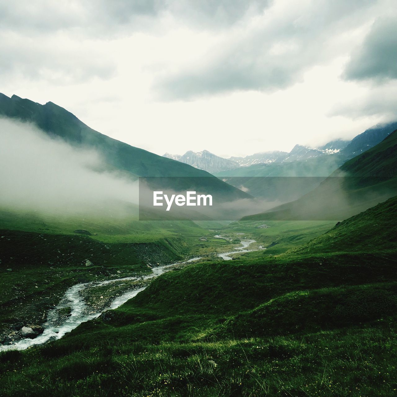 Scenic view of mountain against cloudy sky