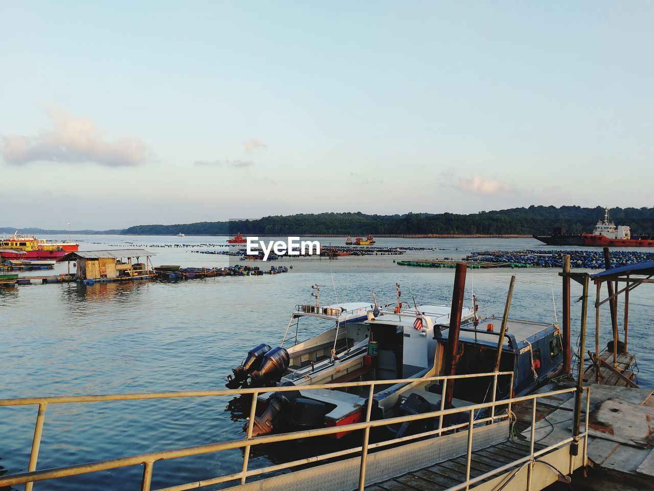 FISHING BOATS IN HARBOR AT SUNSET