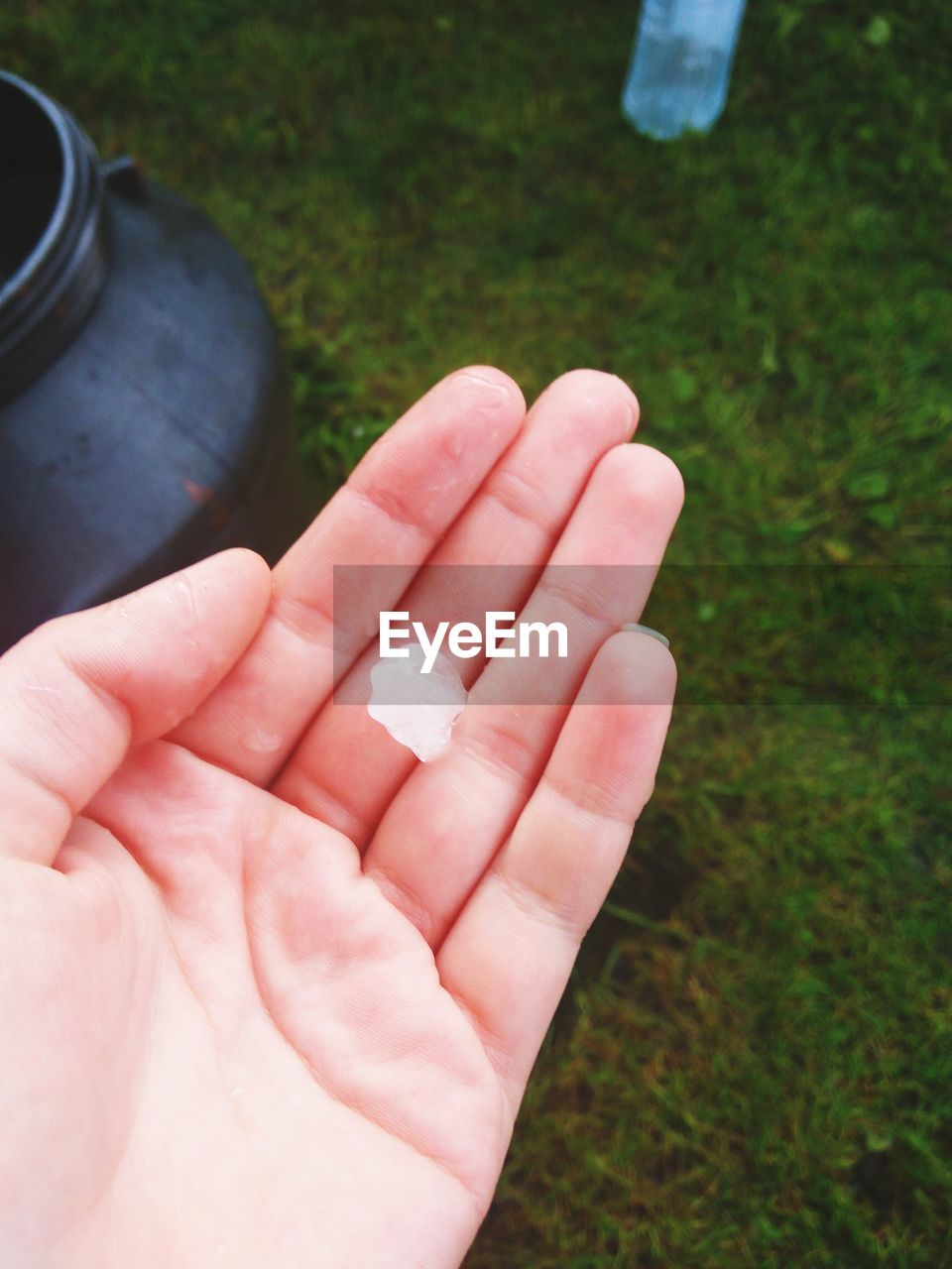 Cropped hand of person holding ice