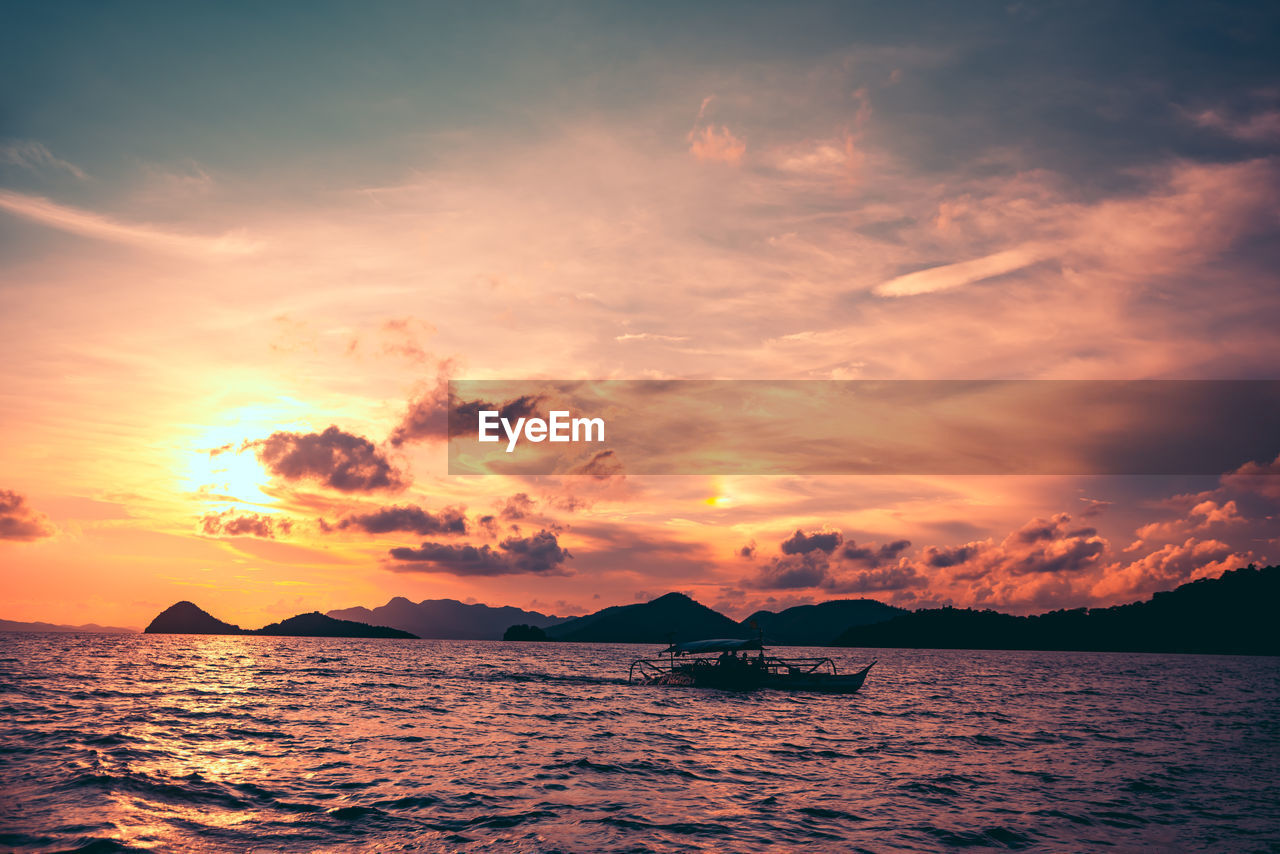 Cruising the seas of coron, palawan at sunset.