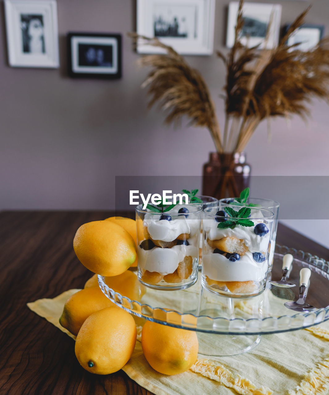 Homemade tiramisu with lemons served on table. top view of delicious dessert in glass cups.