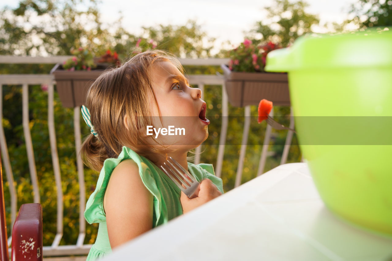 Close-up of girl eating fruit with fork