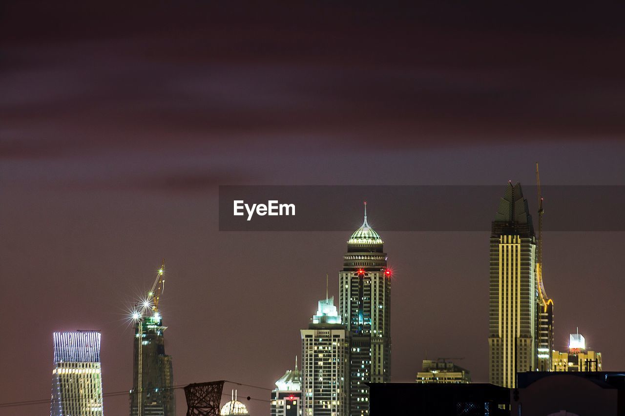 View of skyscrapers lit up at night