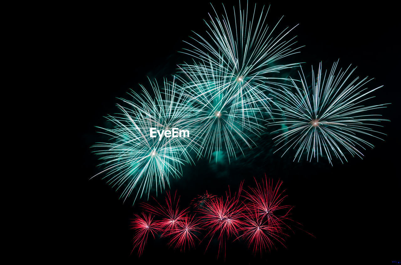 Low angle view of firework display against sky at night