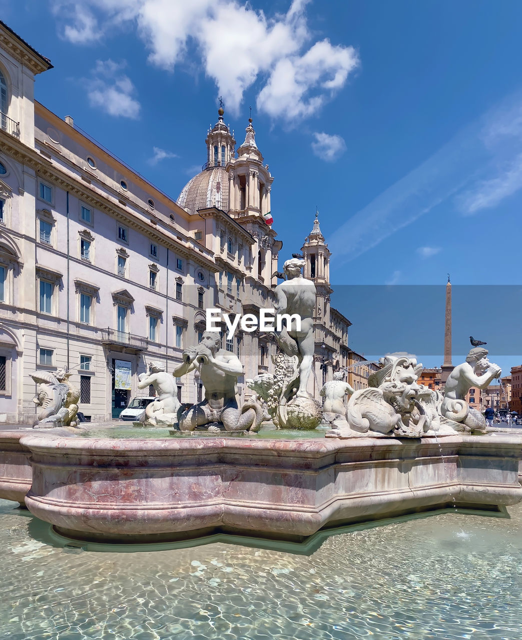 Piazza navona in rome on a sunny day. baroque architecture and marble fountain with statues.