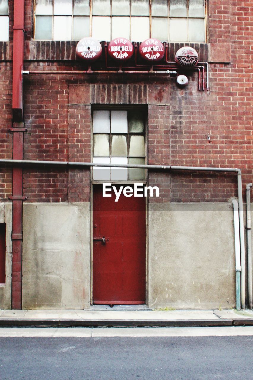 Low angle view of building with red door