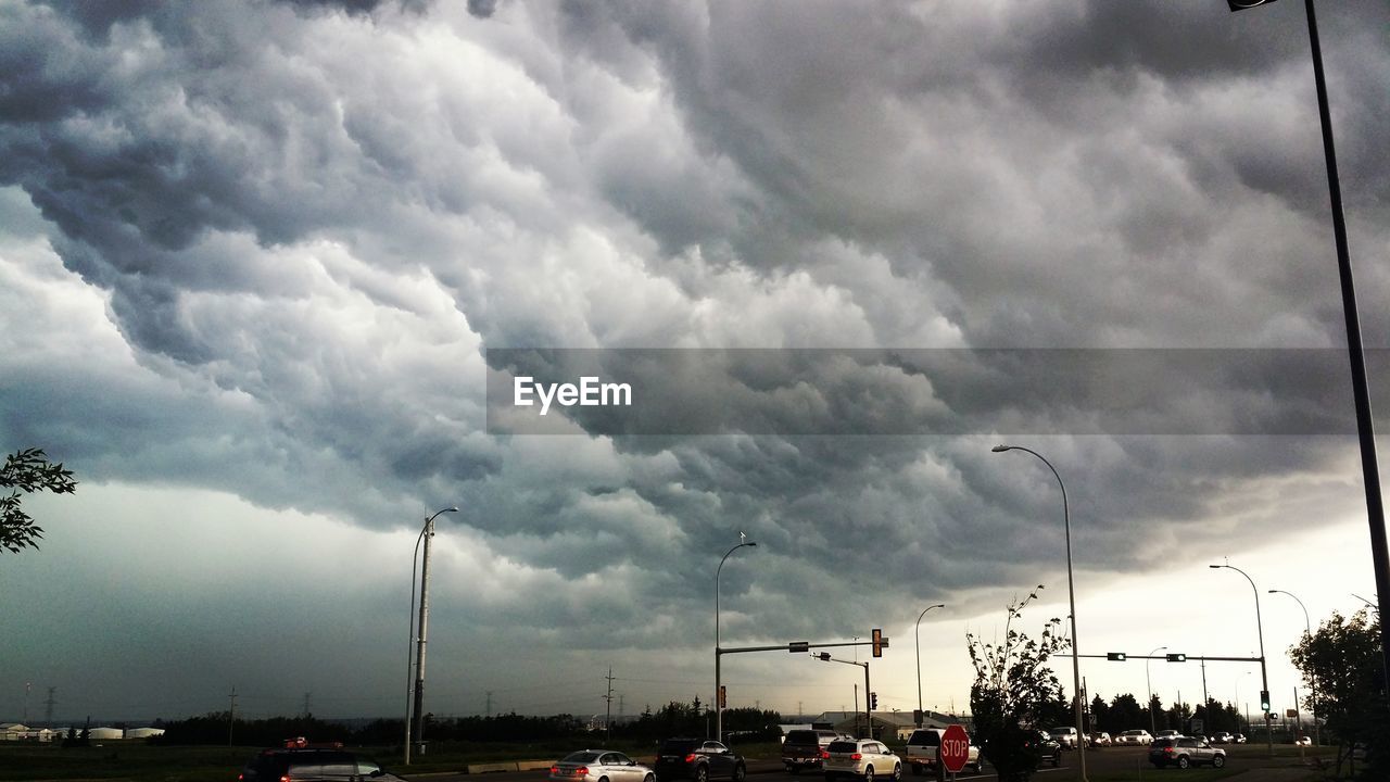 VIEW OF ROAD AGAINST CLOUDY SKY