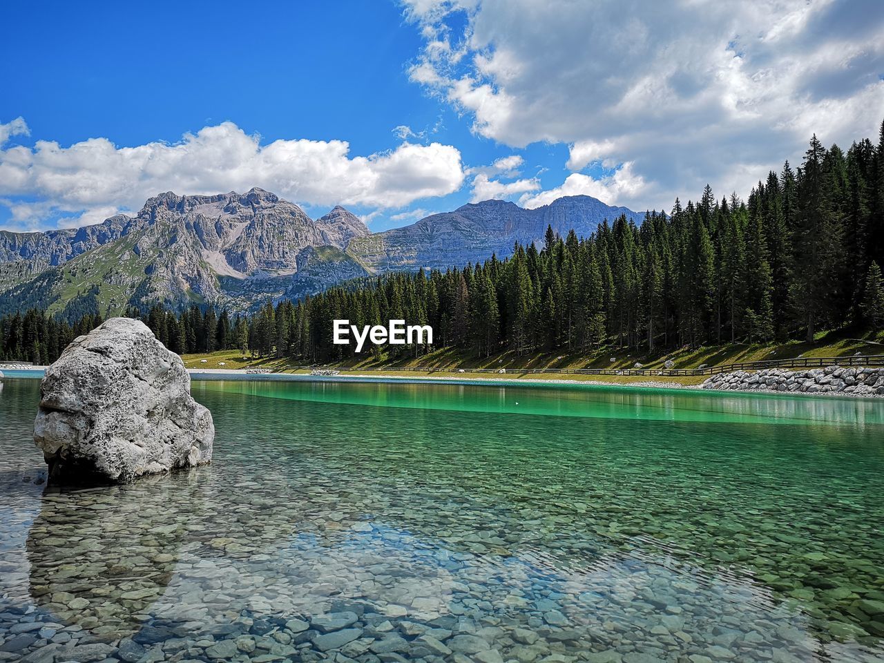 Scenic view of lake and mountains against sky