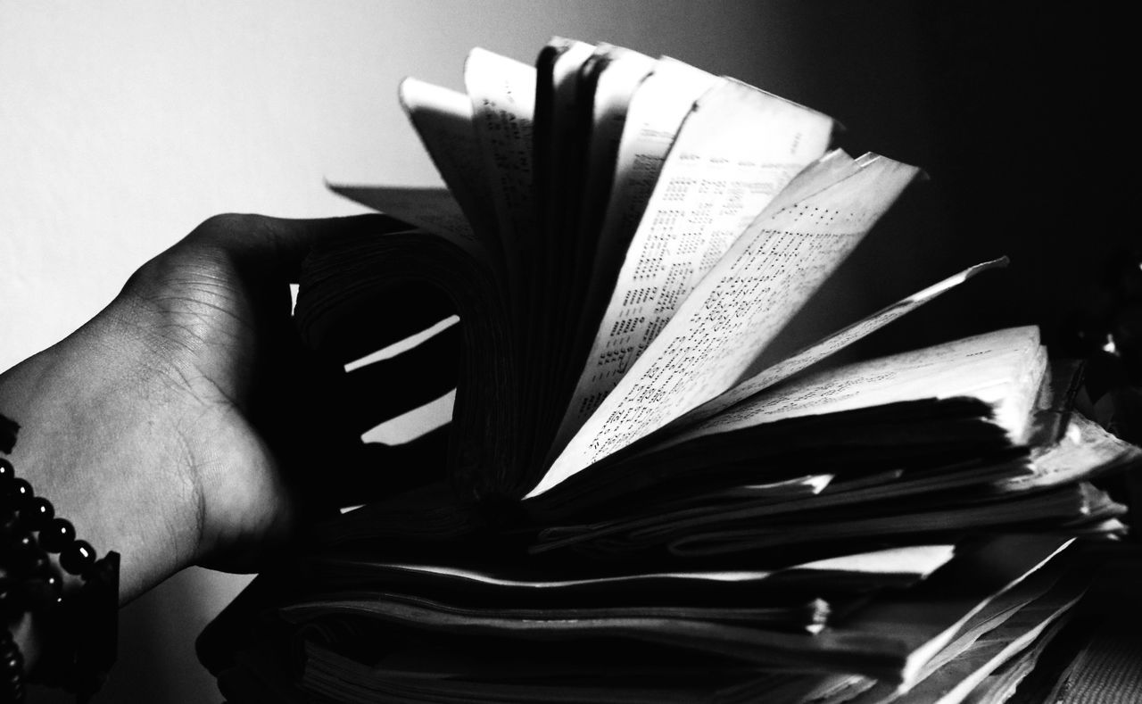 Woman opening book indoors