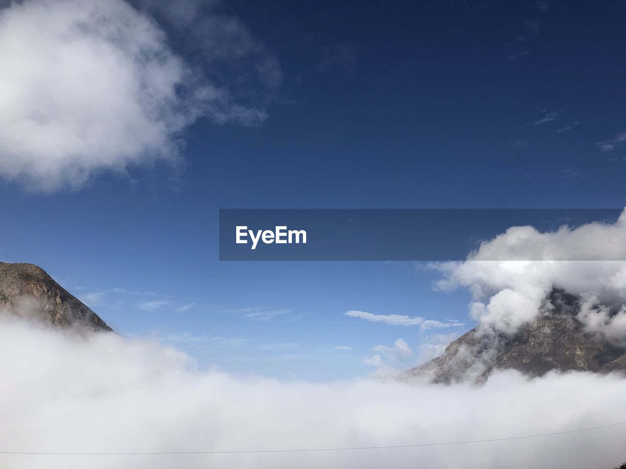 Low angle view of smoke emitting from mountain against sky