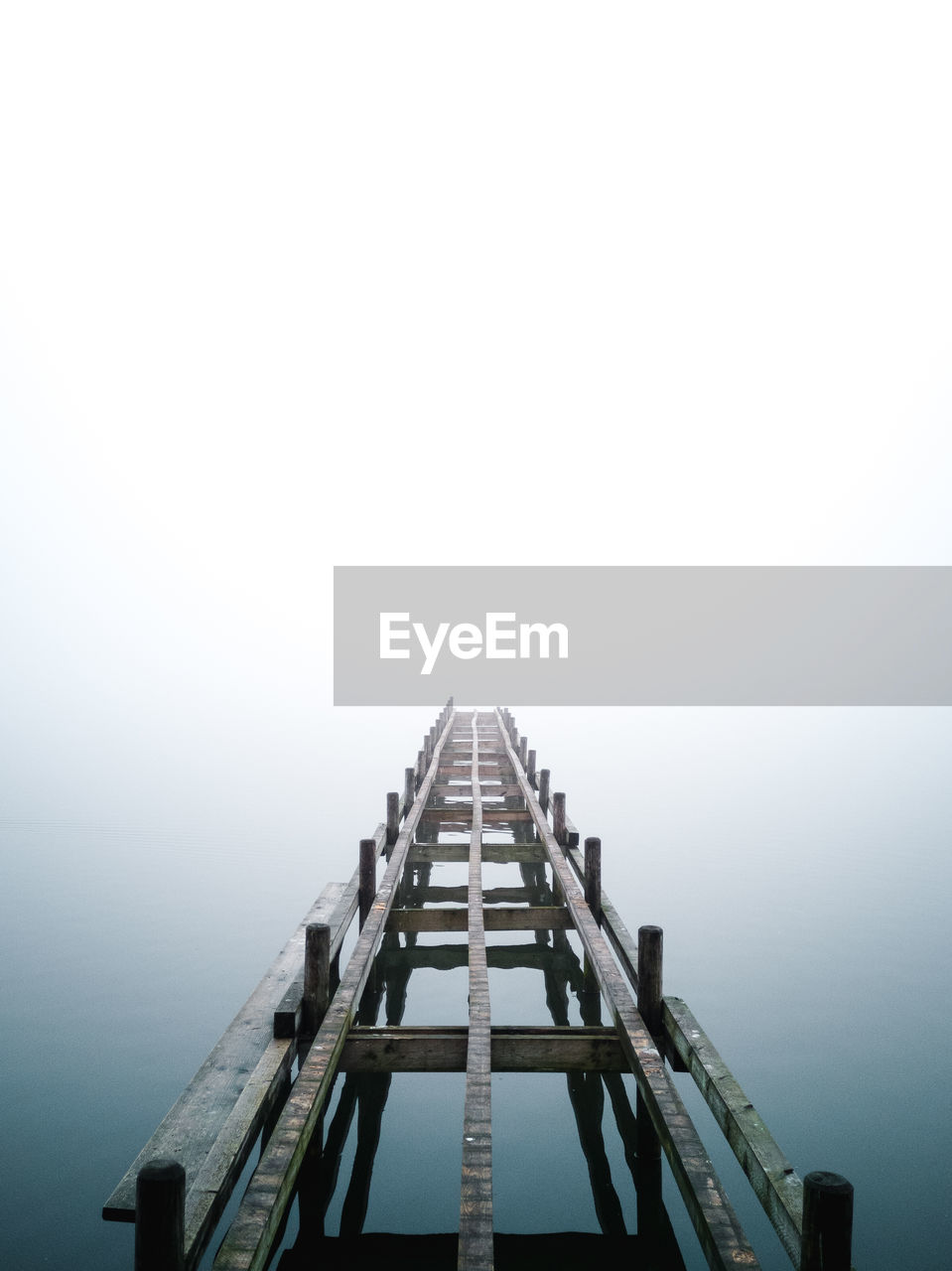 High angle view of pier on lake against sky