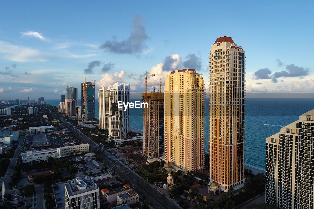 Panoramic view of buildings in city against sky