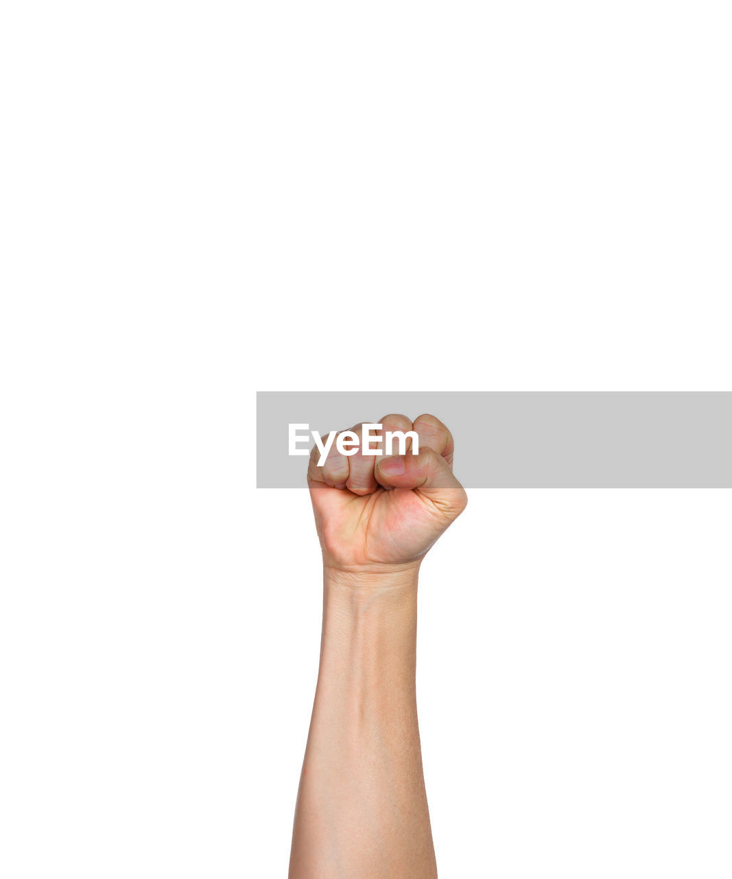 Cropped hand of person showing fist against white background