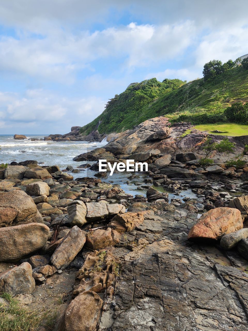 rock, cloud, nature, sky, cliff, adventure, tree, day, plant, terrain, low angle view, outdoors, no people, beauty in nature, scenics - nature, rock formation, land, environment, mountain, tranquility, non-urban scene, sunlight, landscape, geology, textured