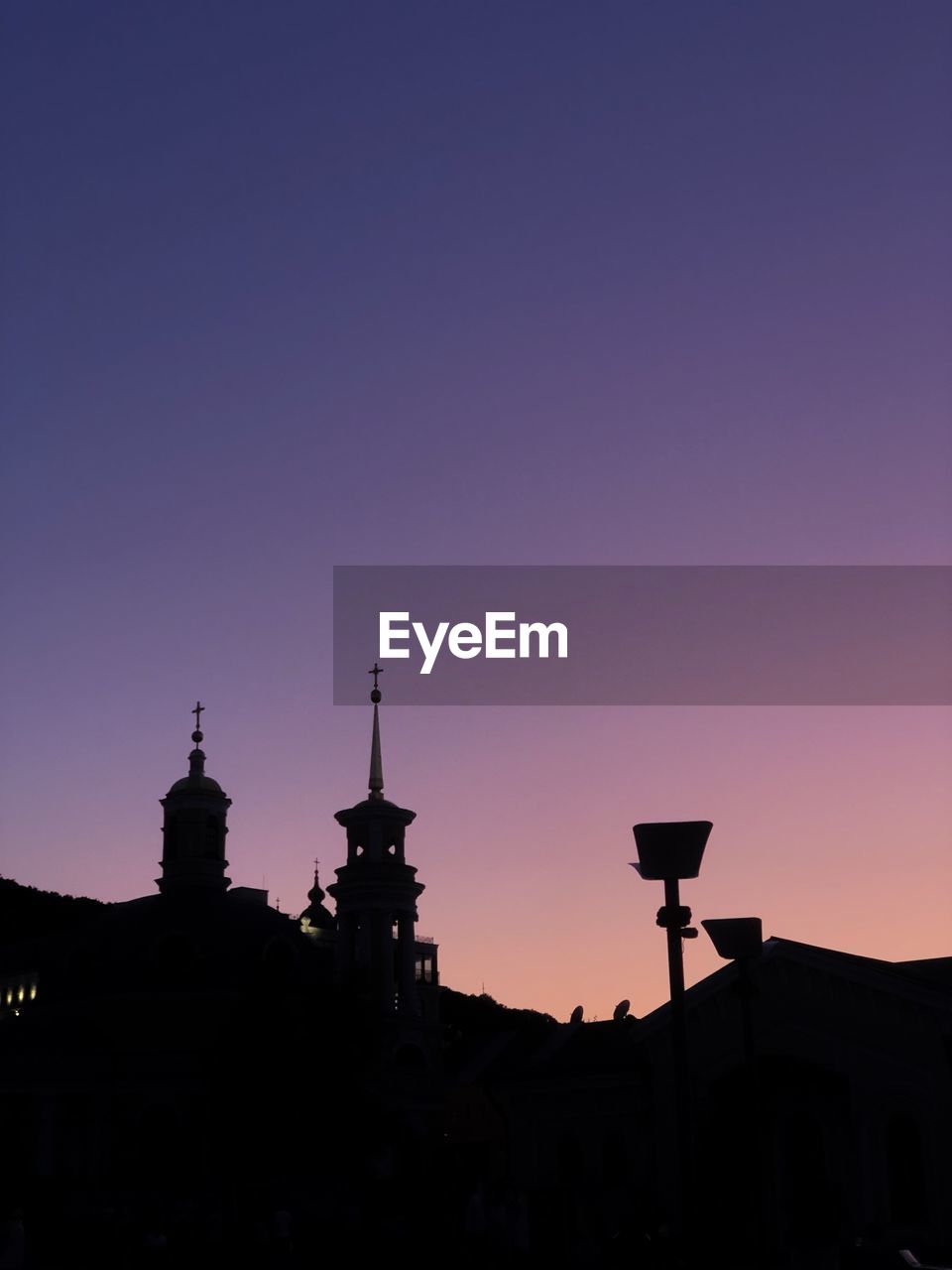 Silhouette buildings against sky during sunset