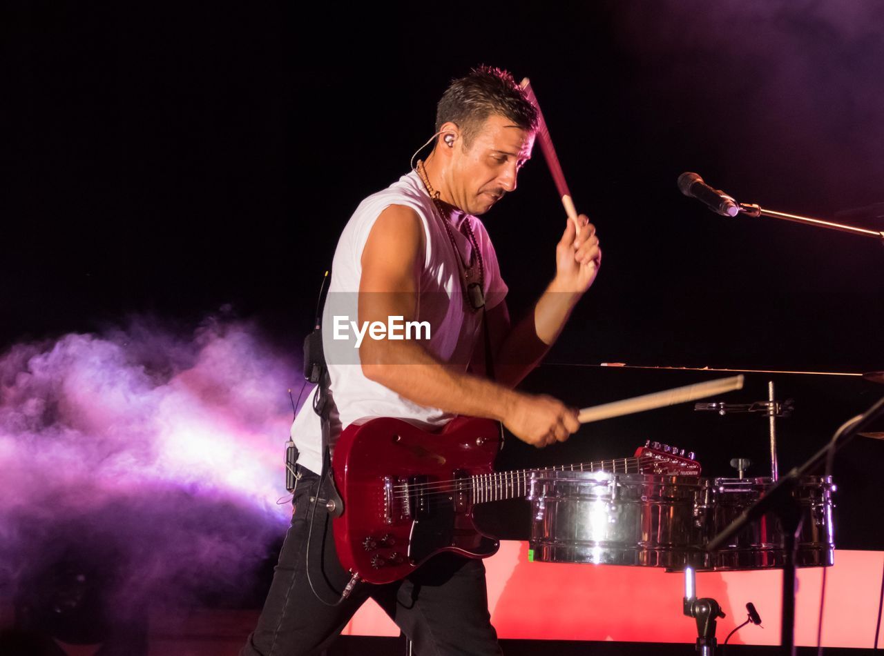 Man playing drum at music concert