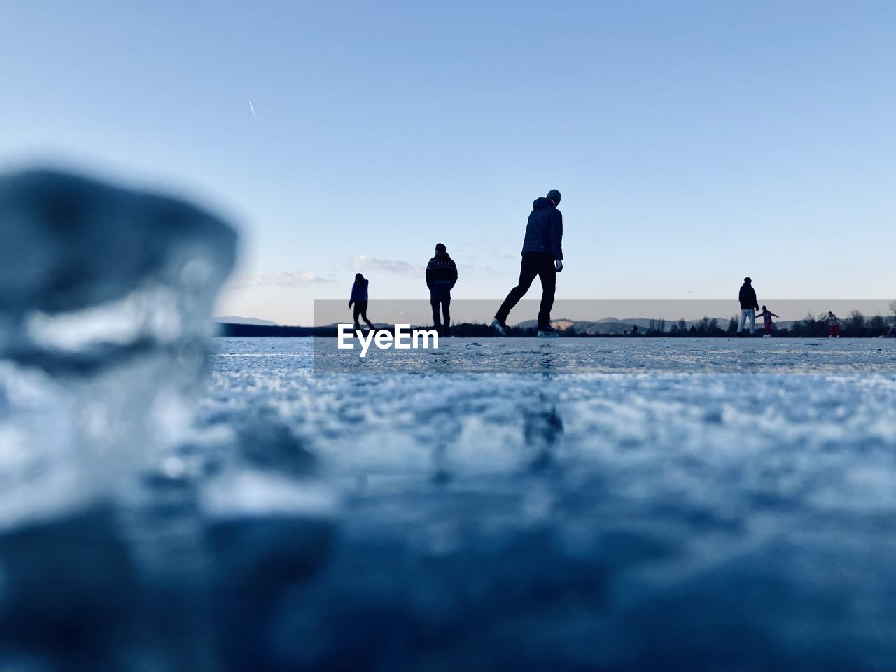 People on sea against clear sky