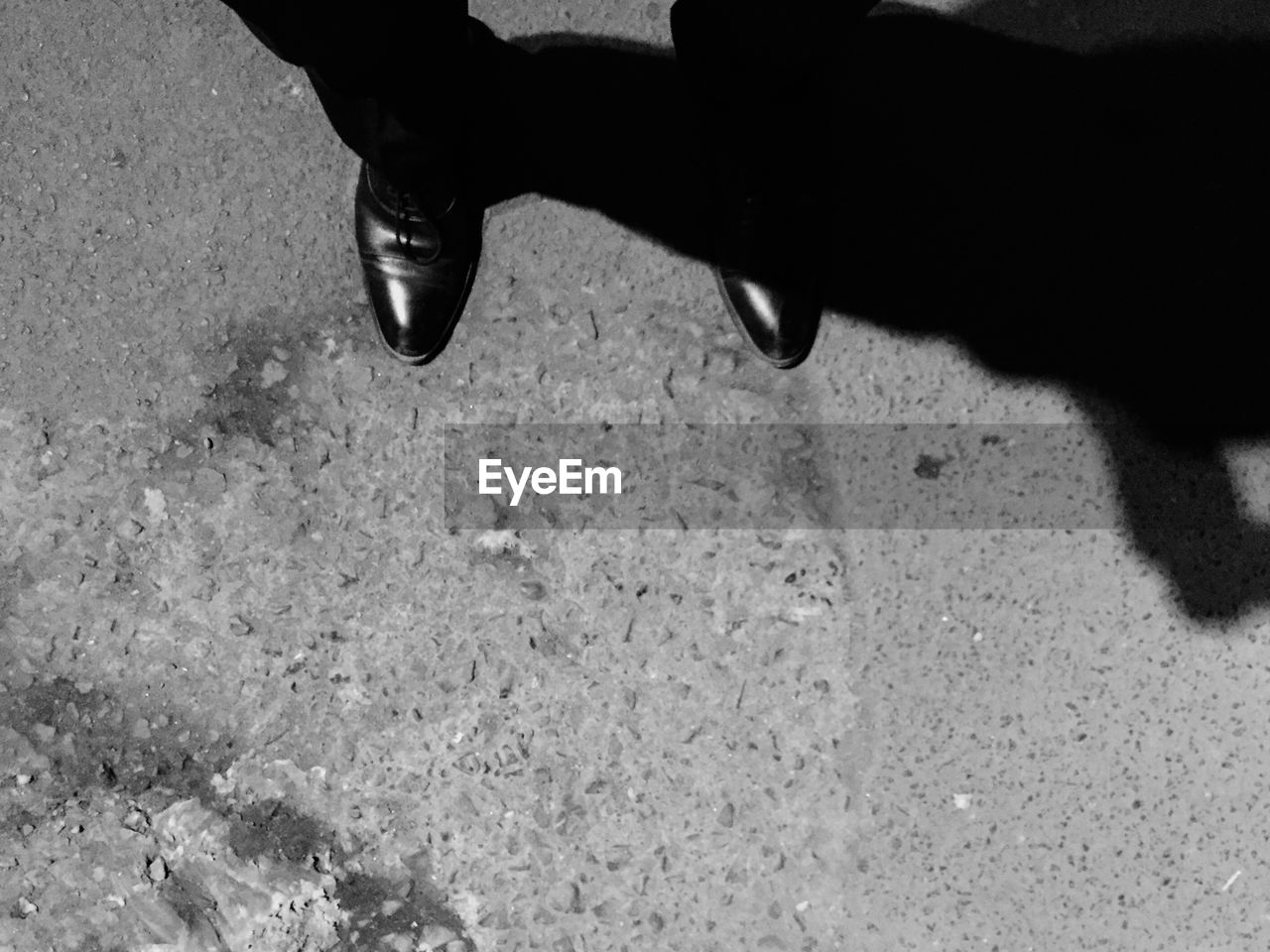 LOW SECTION OF PERSON STANDING ON TILED FLOOR