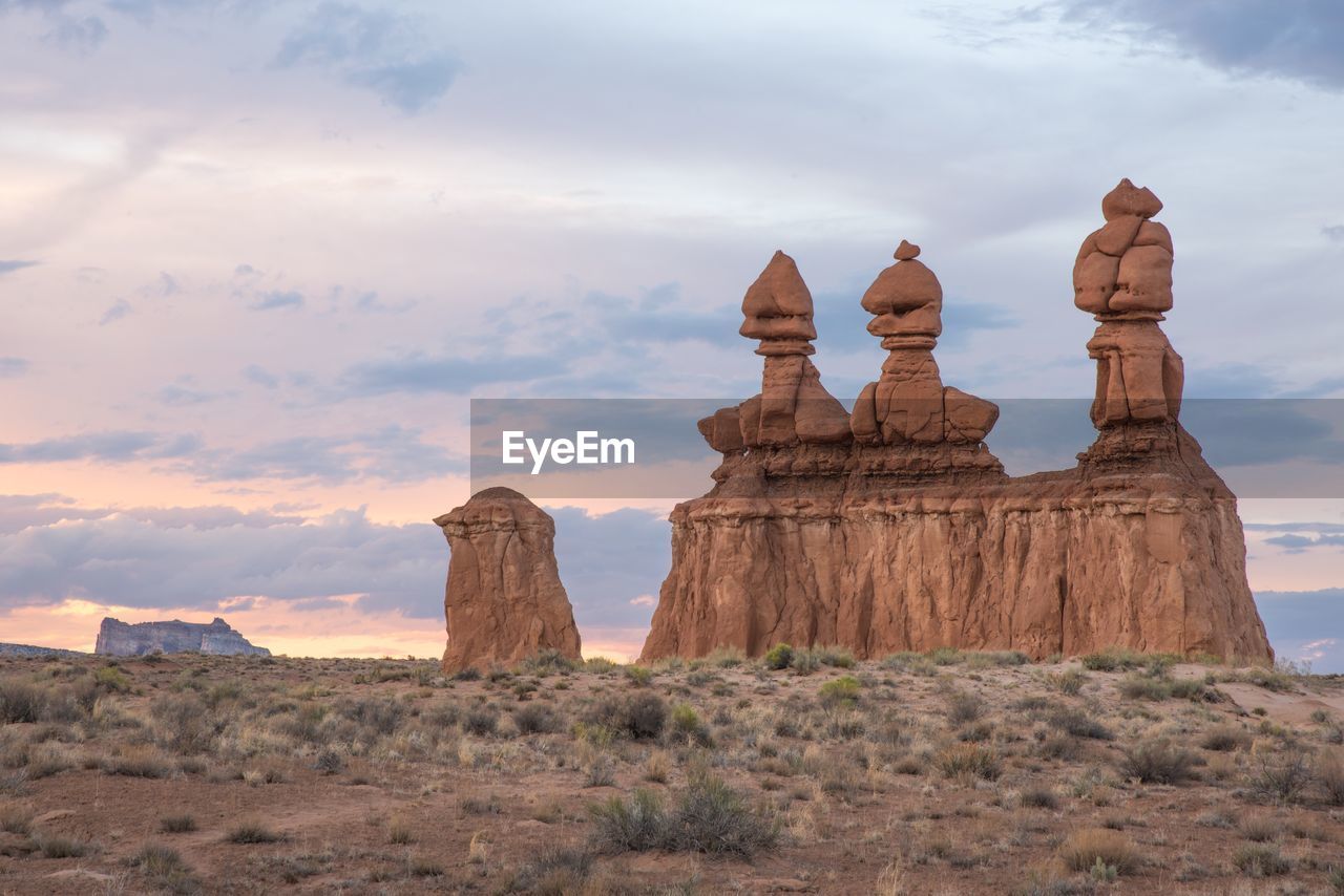 View of rock formations against cloudy sky