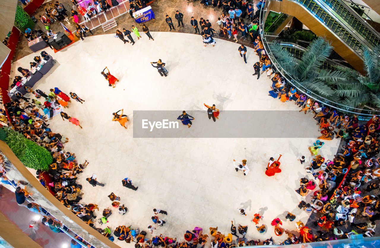 HIGH ANGLE VIEW OF PEOPLE WALKING ON FOOTPATH