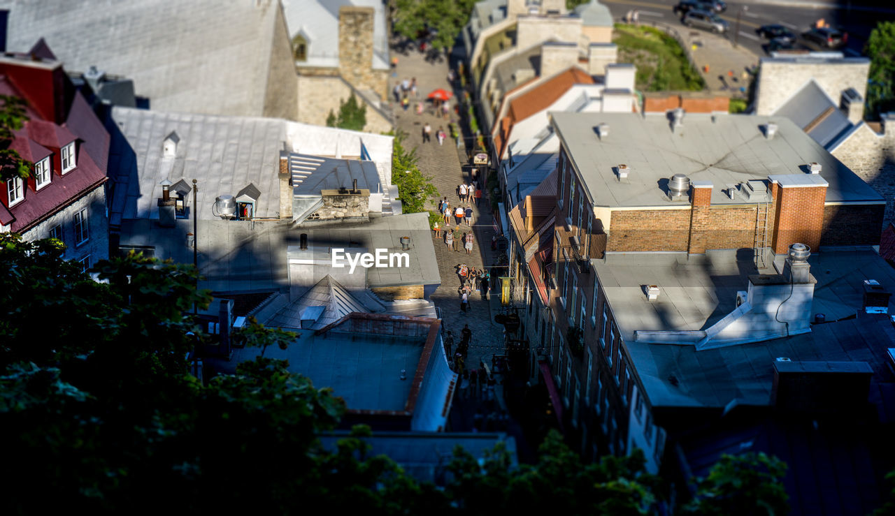 HIGH ANGLE VIEW OF SWIMMING POOL BY BUILDINGS